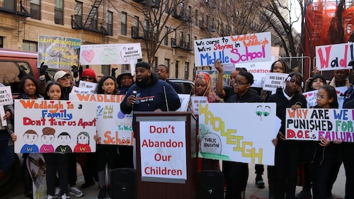 Wadleigh alumni, parents, students, and teachers rally in front of the school to oppose a 2018 proposal to close the middle school grades.